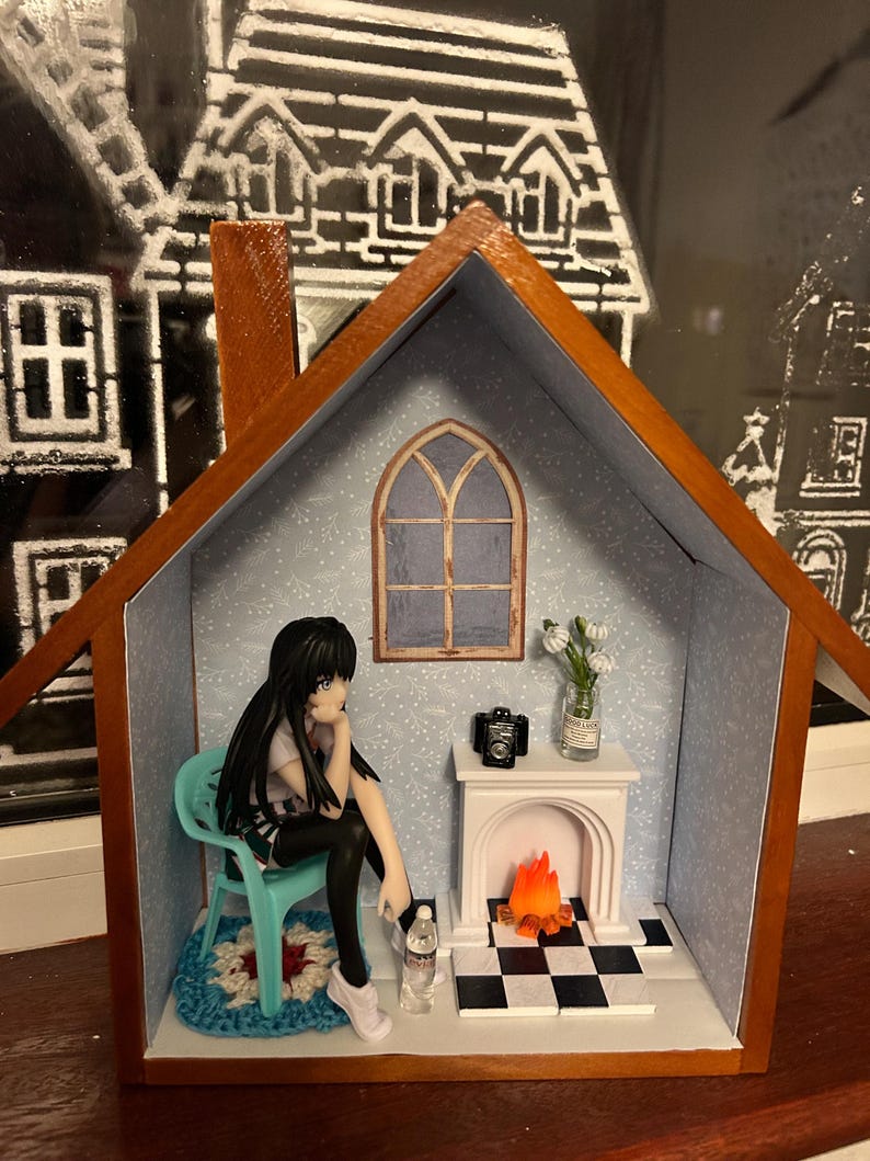 scene on a shelf Anime doll sitting casually by fireside or coffee table scene. — photo 2