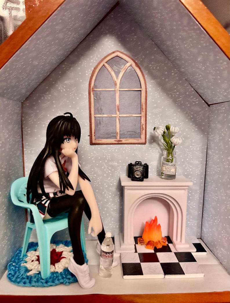 scene on a shelf Anime doll sitting casually by fireside or coffee table scene. — photo 3
